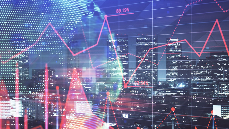 Stock charts imposed over a picture of cities skyline.
